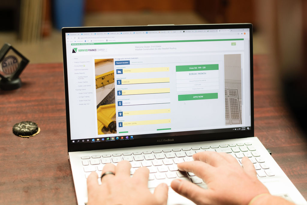 Service Finance Company web page open on a laptop computer