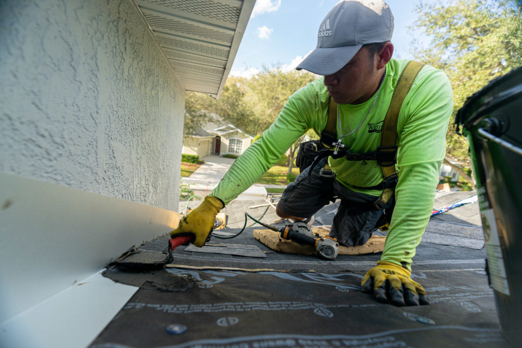 roofer sealing a new roof in Florida.