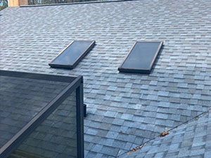 new asphalt shingle roof with two skylights.